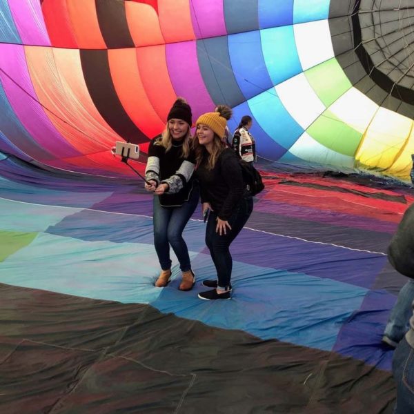 Two young ladies taking a selfie in the hot air balloon